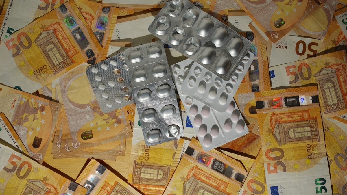 A pile of silver dices sitting on top of a pile of money